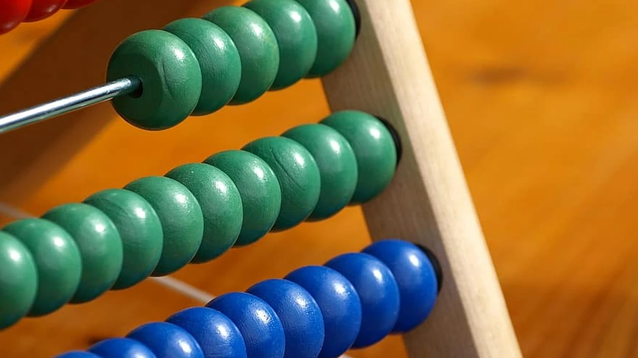 Close up on a plate of mashed potatoes, topped with baked pork chops with cream of mushroom soup, and a side of green beans.